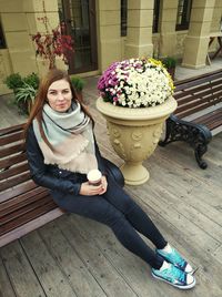 Portrait of smiling woman sitting outdoors