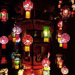 Low angle view of illuminated lanterns at night