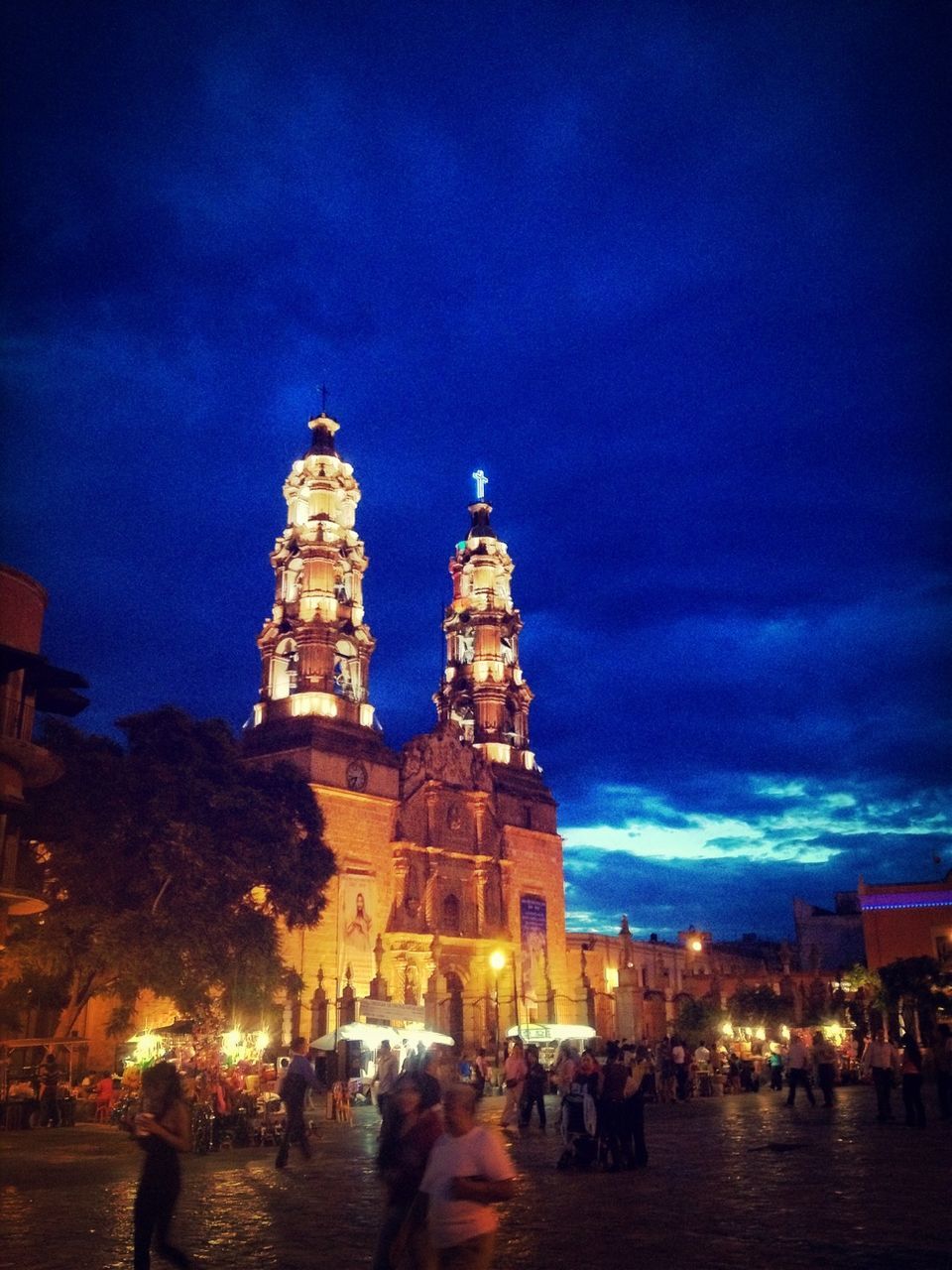 building exterior, large group of people, architecture, illuminated, built structure, sky, lifestyles, person, night, men, leisure activity, mixed age range, dusk, city, blue, travel destinations, famous place, tourism, city life