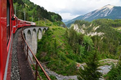 Passenger train on bridge in mountains