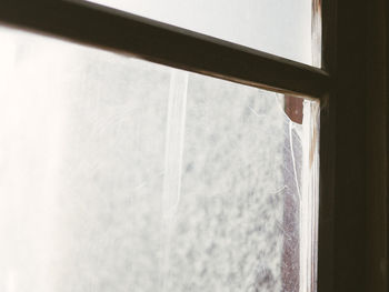 Close-up of broken window glass in abandoned building