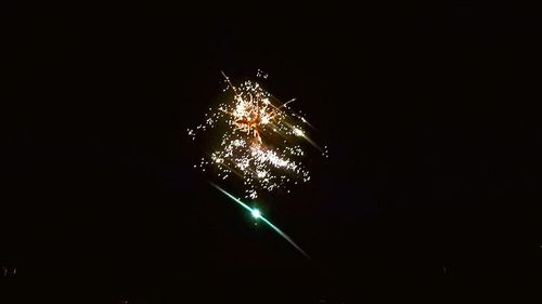 Low angle view of firework display at night