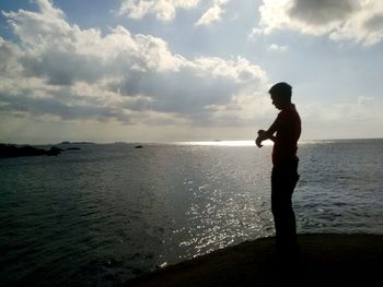 Side view of silhouette man standing at beach