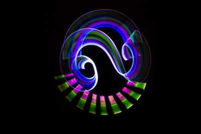 Close-up of illuminated lights against black background