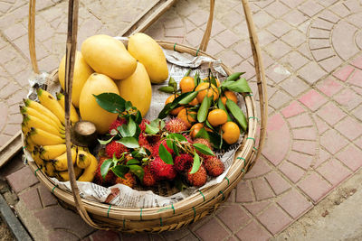 High angle view of fruits in basket on footpath