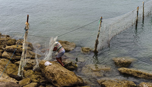 High angle view of man fishing in sea