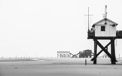 Lifeguard hut on beach against clear sky