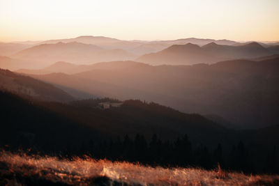 Scenic view of silhouette mountains against sky during sunset