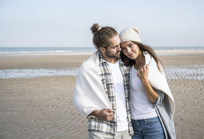 Young couple kissing on beach