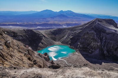 Scenic view of volcanic landscape against blue sky