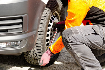 Low section of man holding car