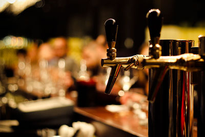 Close-up of beer taps at bar