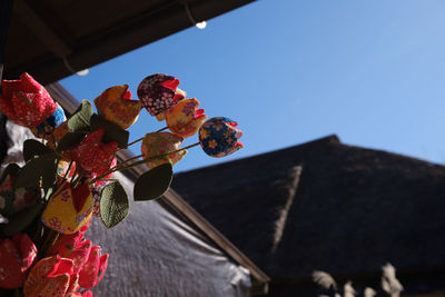 Low angle view of lanterns hanging against sky