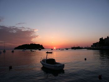 Boat in sea at sunset