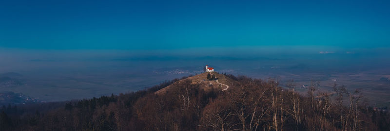 View of house on hill against landscape