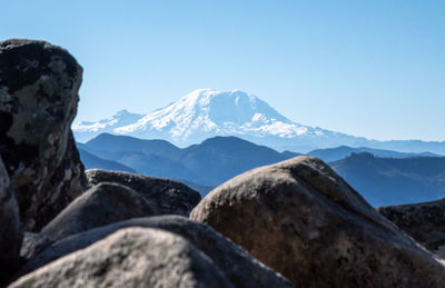 Mount rainier in the distance with boulder rocks in the foreground.