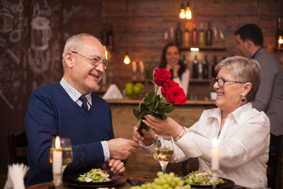 Portrait of senior couple holding flowers