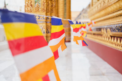 Close-up of multi colored buddhist flags hanging outside building