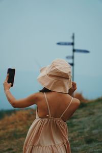 Woman photographing with mobile phone