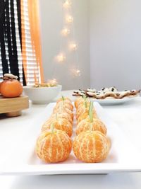 Close-up of orange slices in plate on table