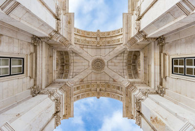 Low angle view of building against cloudy sky