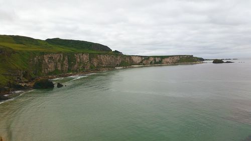 Scenic view of calm sea against cloudy sky