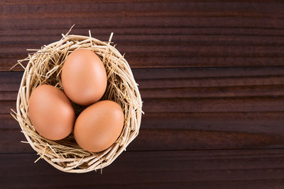 High angle view of eggs in basket on table