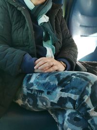 Close-up of woman hand holding umbrella in winter