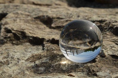 Close-up of crystal ball on rock