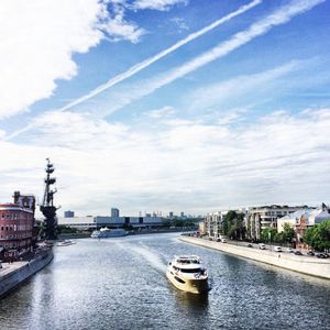 Boats in river with buildings in background