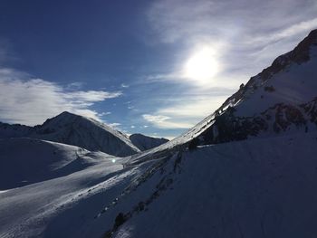 Scenic view of snowcapped mountains against sky during winter