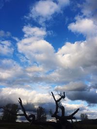 Low angle view of silhouette sculpture against sky