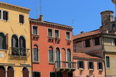 Low angle view of buildings against blue sky