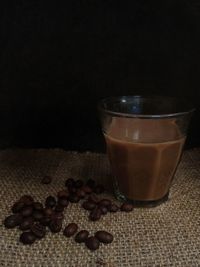 Close-up of coffee beans in glass on table