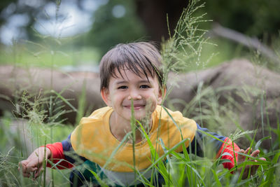 Portrait of smiling boy with plants