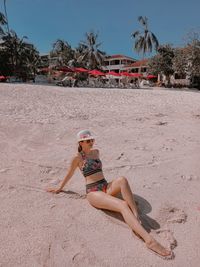 Woman on beach against sky