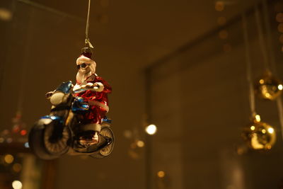 Low angle view of santa clause toy hanging indoors