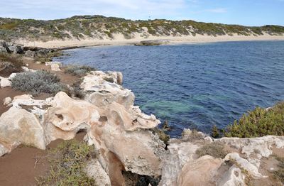 Rock formation by sea against sky at cape peron