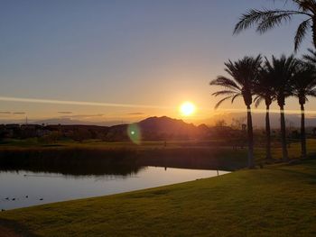 Scenic view of lake against sky during sunset