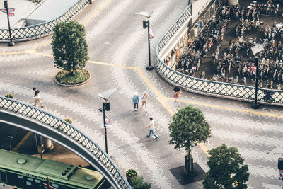 High angle view of people walking on road