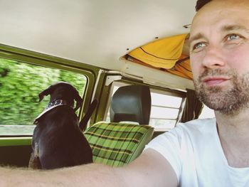 Portrait of man sitting in car