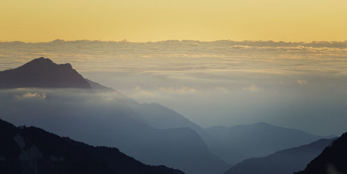 Scenic view of silhouette mountains against sky during sunset