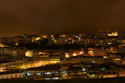 High angle view of illuminated buildings in city at night