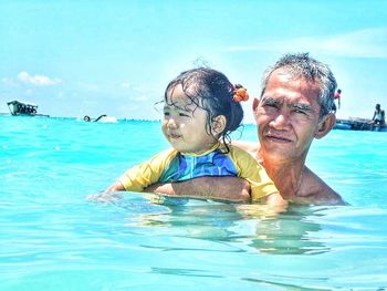 High angle view of smiling young woman in sea