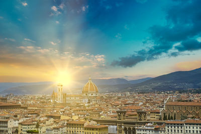 Aerial view of townscape against sky at sunset