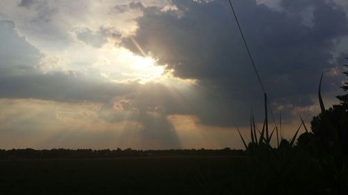 Scenic view of landscape against cloudy sky