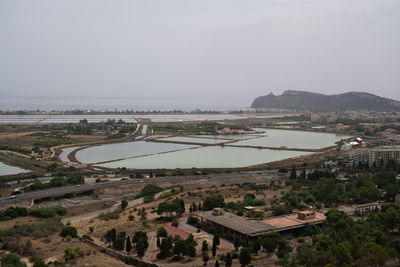High angle view of townscape by sea against sky