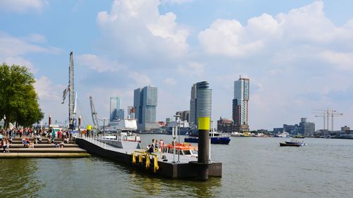 Boats in river with city in background