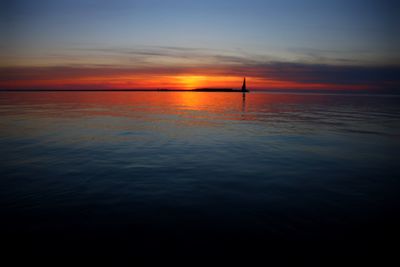 Scenic view of sea against romantic sky at sunset