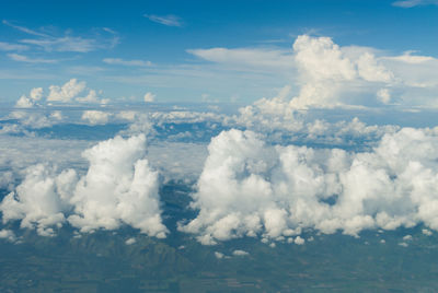 Aerial view of clouds over the green mountain range.
